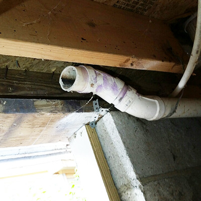 Waste pipe in a crawl space that was cut and did not connect to the sewer pipe, but rather ended and dumped onto the floor of the crawl space.